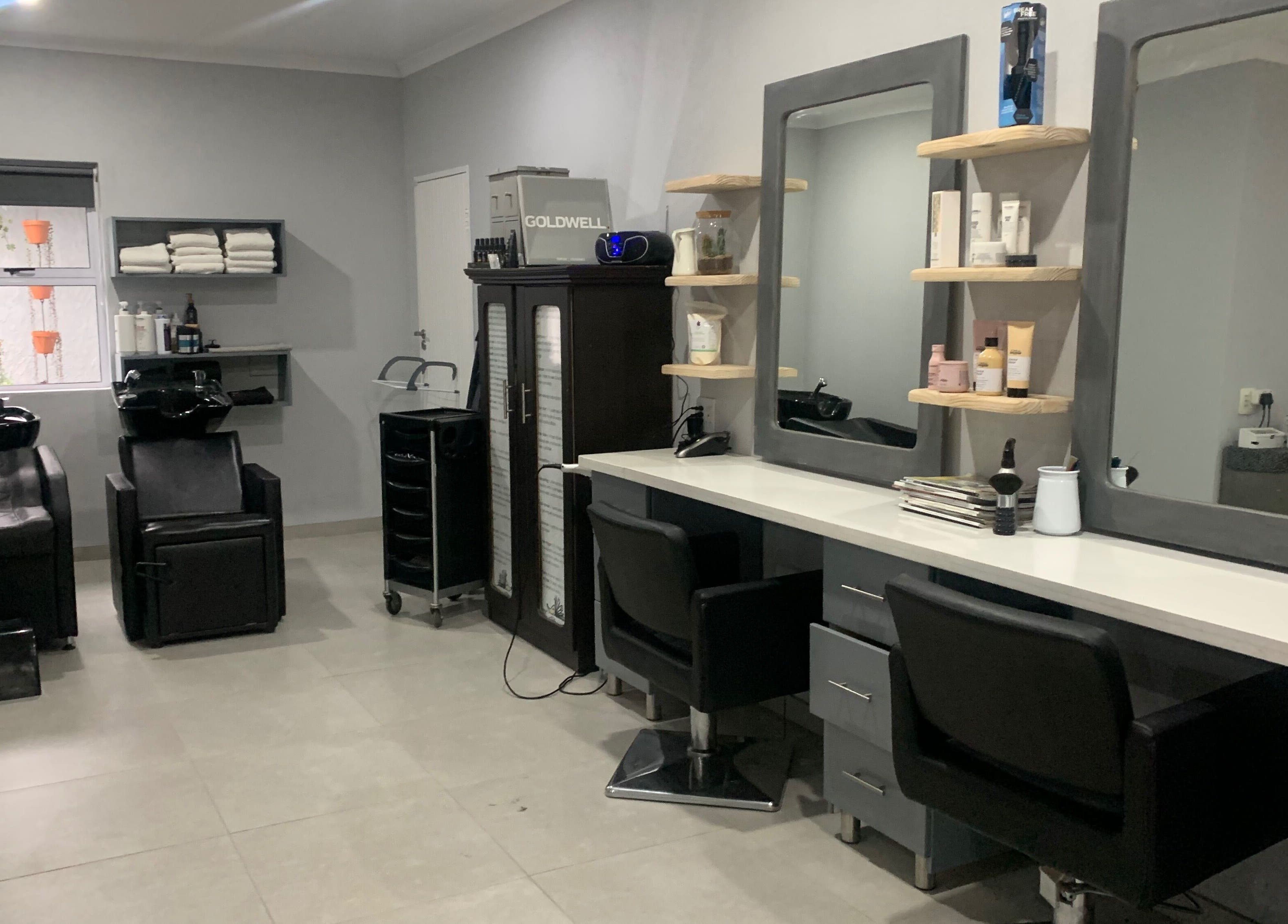 Modern interior of Headjogs Hairdressing, Sandton, Gauteng, ZA, featuring sleek salon chairs and styling stations.