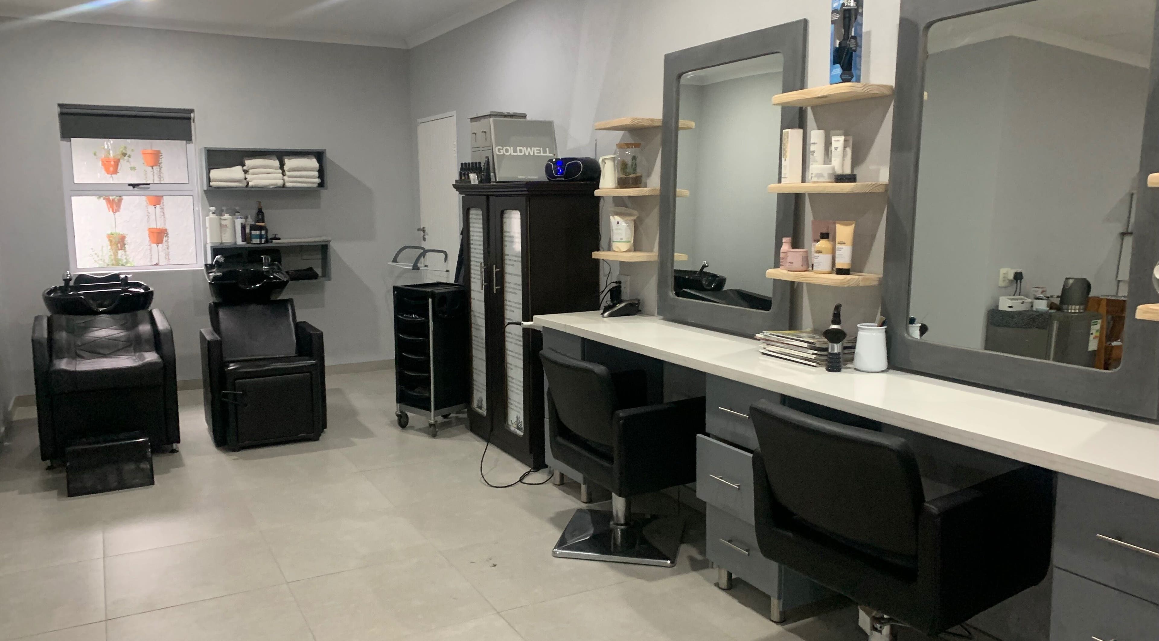 Modern interior of Headjogs Hairdressing, Sandton, Gauteng, ZA, featuring sleek salon chairs and styling stations.