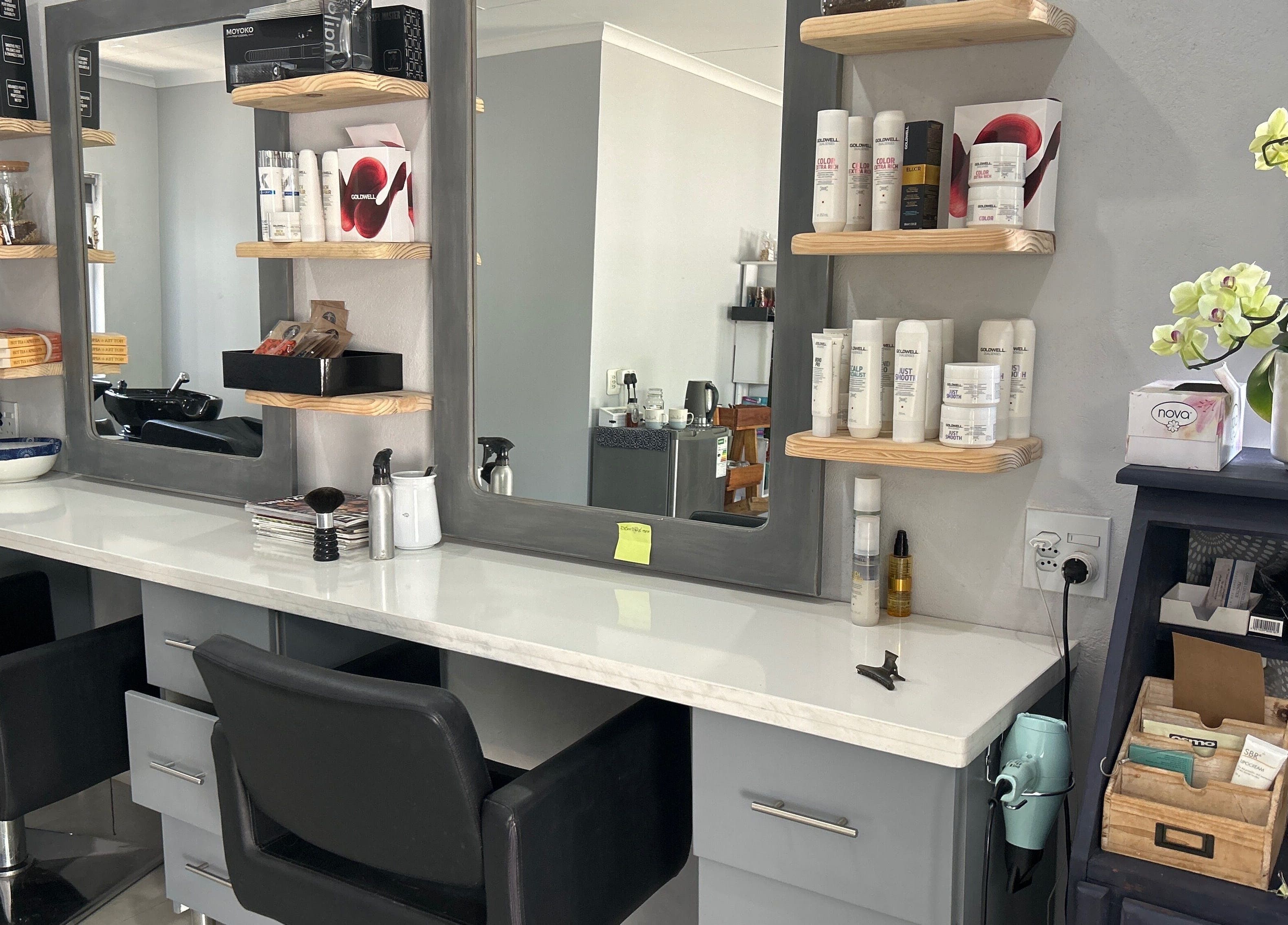 Hairdressing station at Headjogs Hairdressing, Sandton, Gauteng, ZA, showcasing modern equipment and decor.