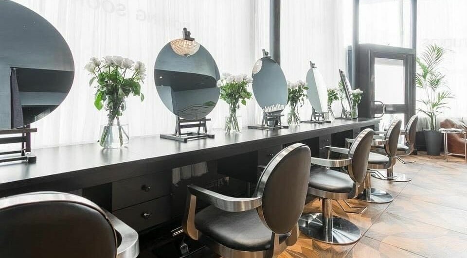 Modern salon chairs and mirrors at WSSTUDIOS Hair Professionals, London, England, GB.