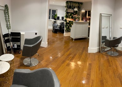 Elegant interior of Salon No.6 Hair And Beauty, Norwich, England, featuring modern chairs and wooden flooring.