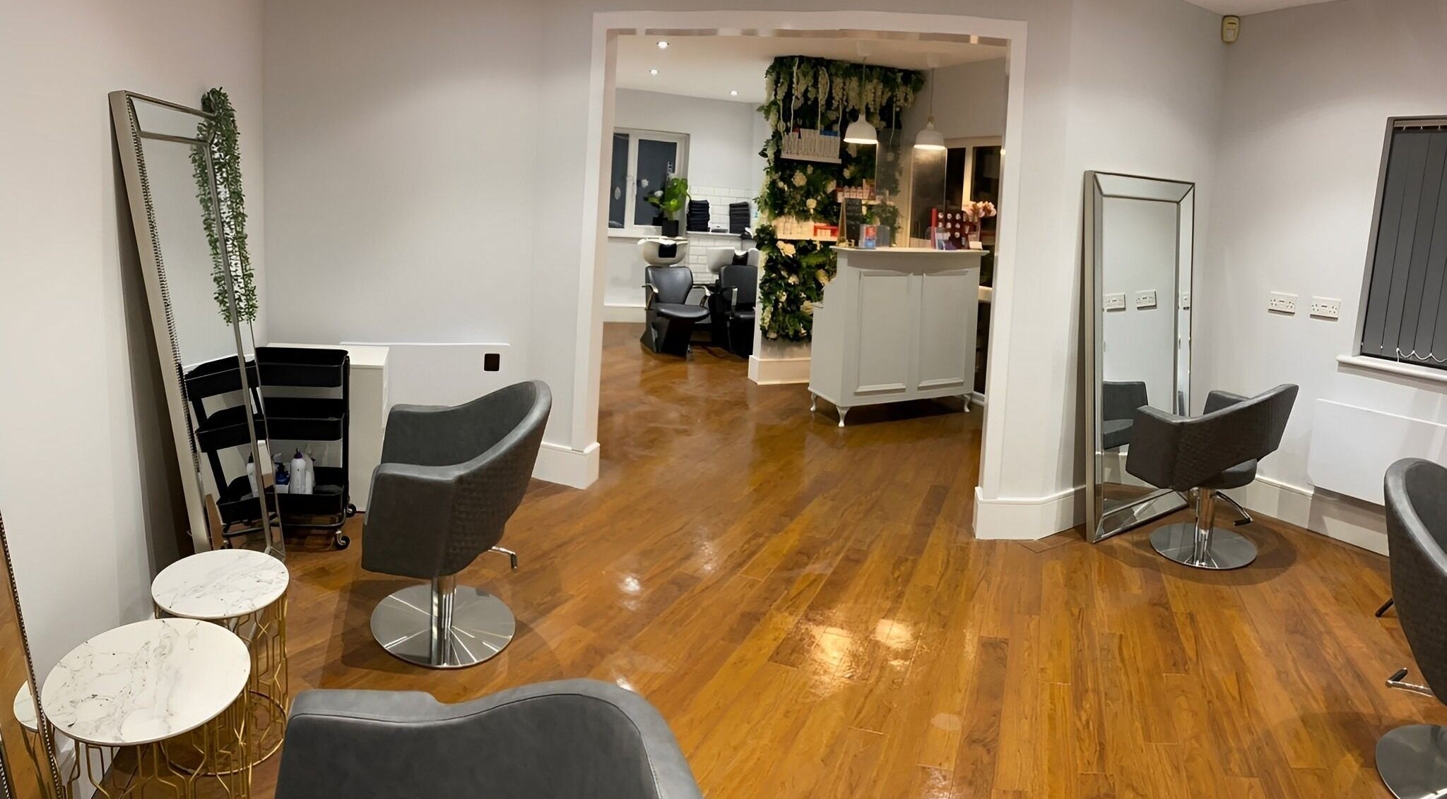 Modern interior at Salon No.6 Hair And Beauty in Norwich, England, GB with stylish chairs and mirrors.