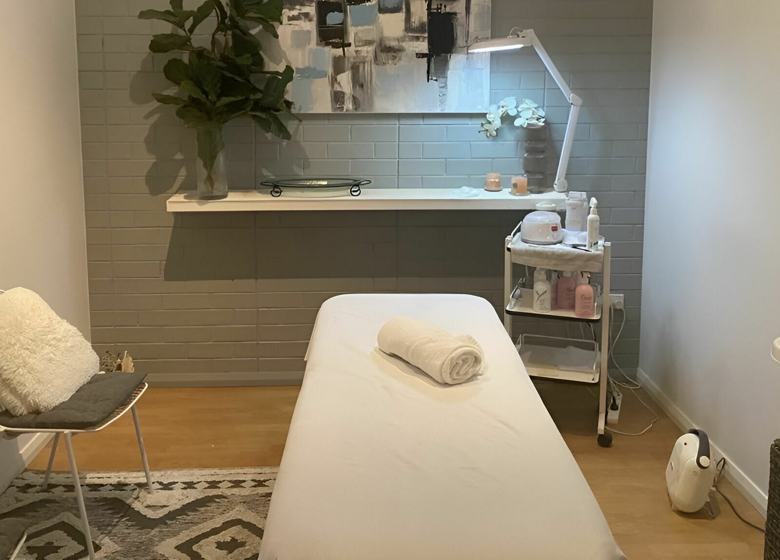 Cozy treatment room at Dynamic Skin Services, Crawley, Western Australia, AU, featuring a massage table and decor.