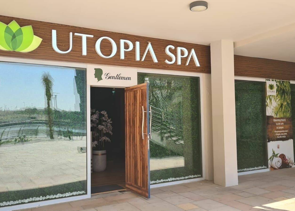 Utopia Spa entrance in Dubai, Dubai, AE with greenery and inviting open door.