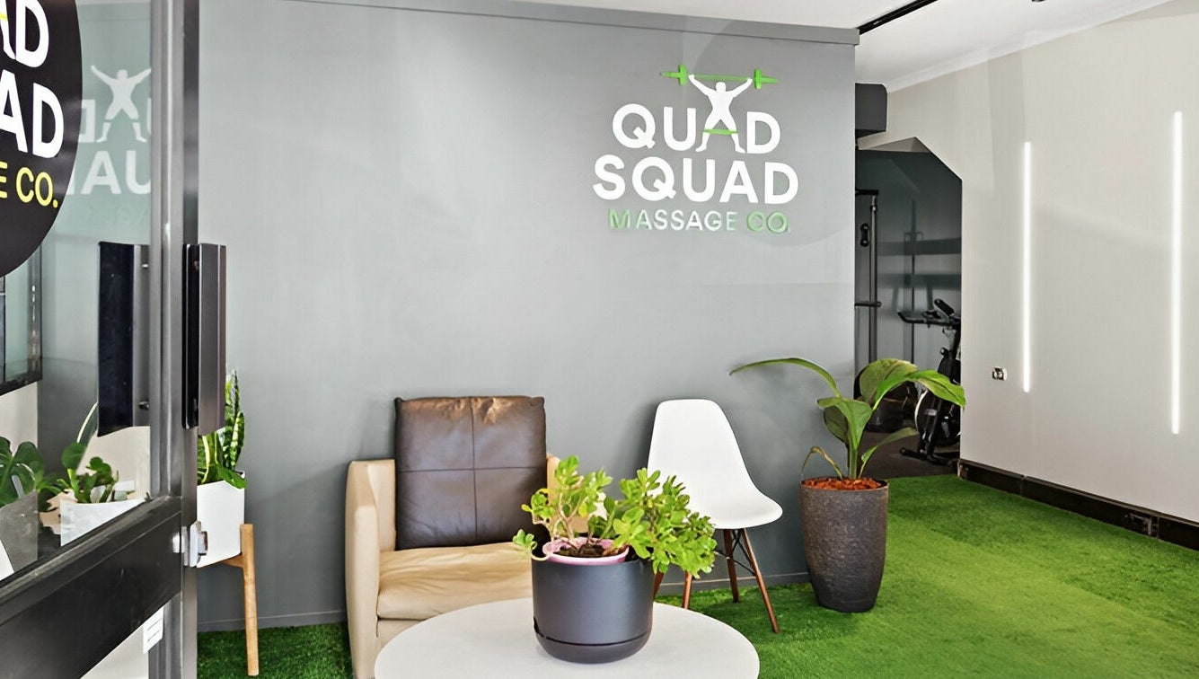 Inviting lobby at Quad Squad Massage Co, Rosebery, New South Wales, AU with cozy seating and lush plants.