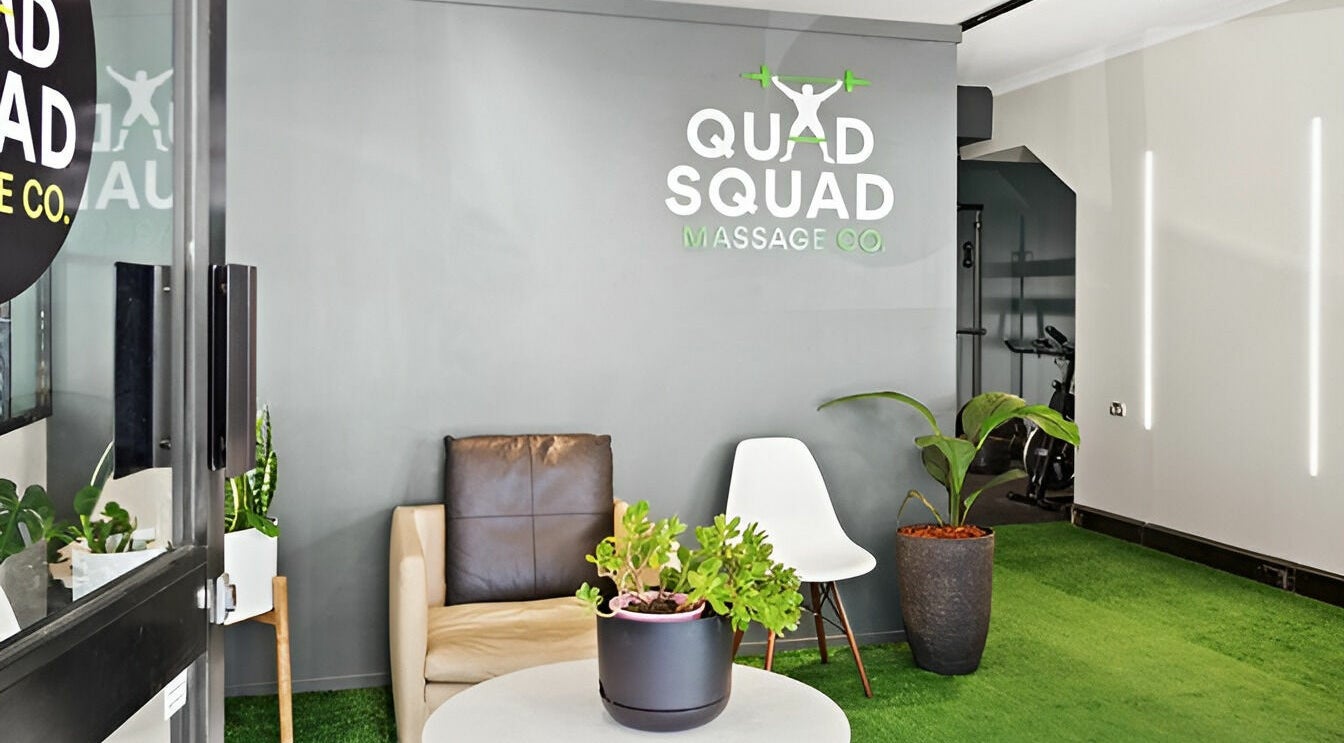 Inviting lobby at Quad Squad Massage Co, Rosebery, New South Wales, AU with cozy seating and lush plants.