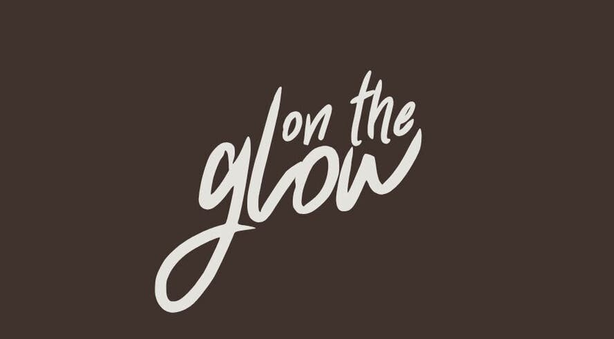 Logo of On the Glow Spray Tans in Alliance, Ohio, US on a dark background.