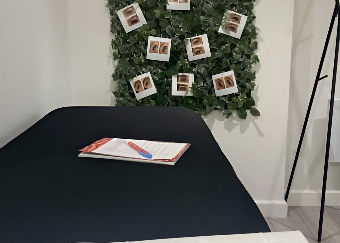 Calm treatment room at Lashes by Georgina in Andover, England, GB, showcasing a bed and green decor.