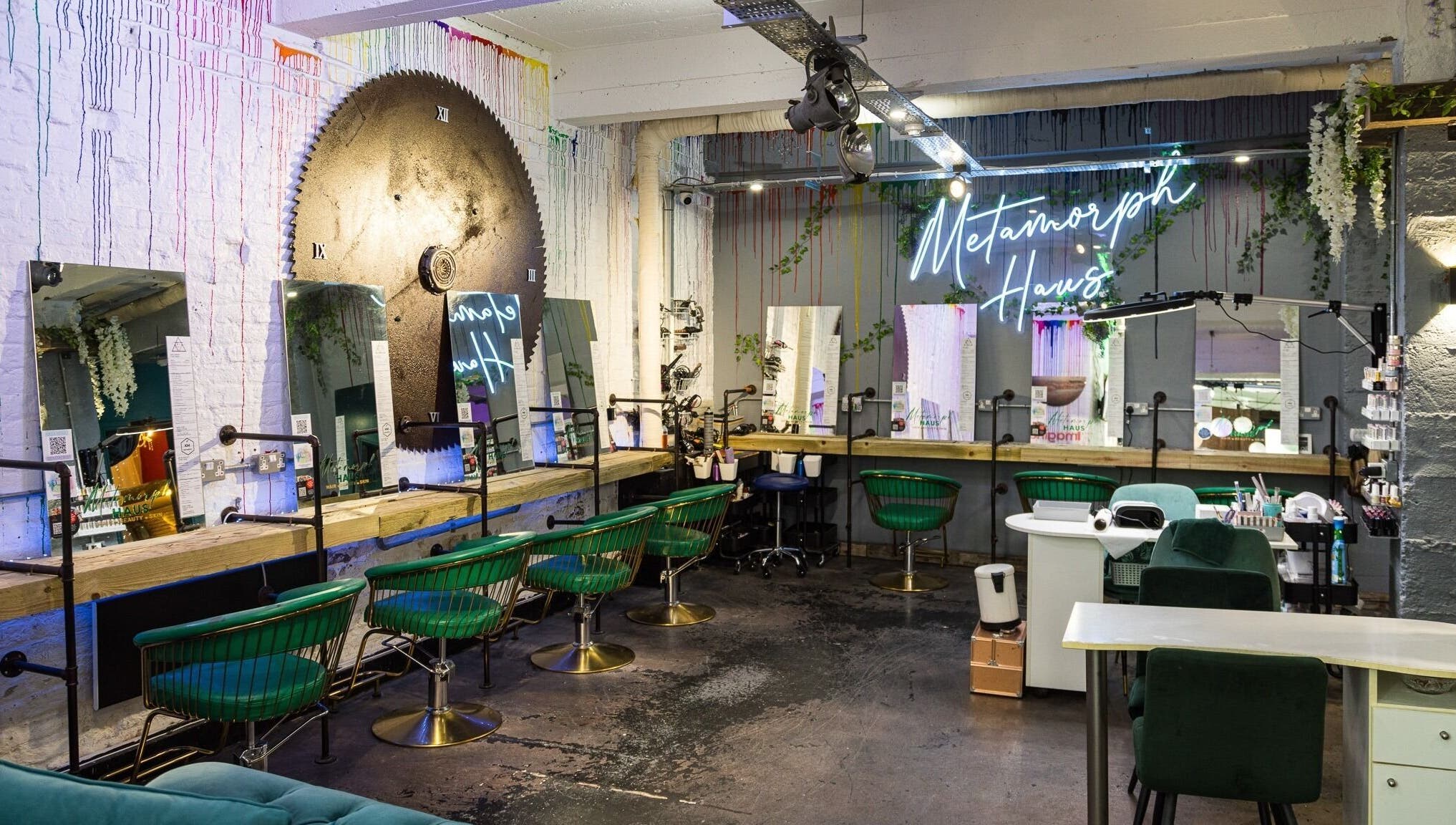 Modern salon interior at Metamorph Haus, Liverpool, England, GB with stylish seating and neon sign.