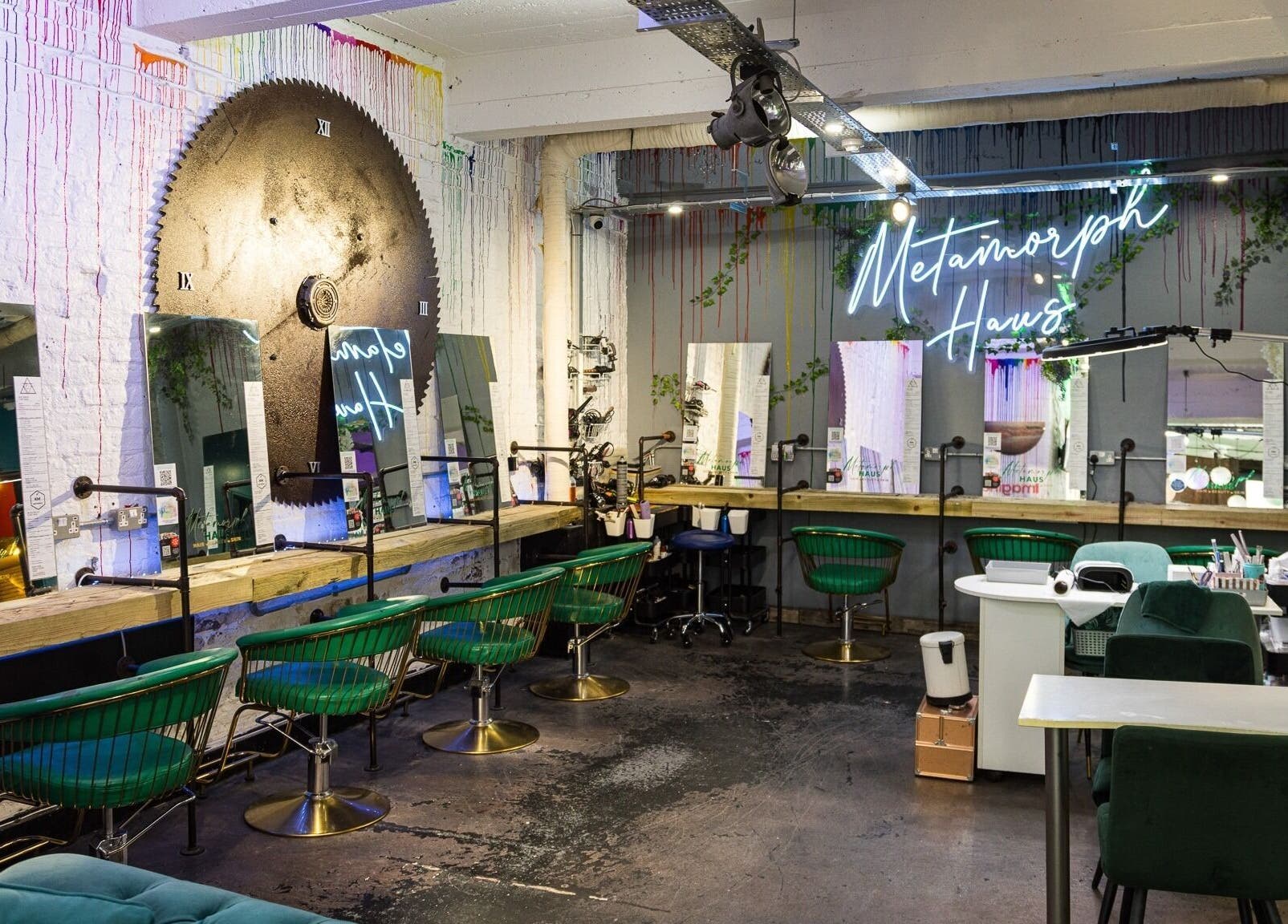 Modern salon interior at Metamorph Haus, Liverpool, England, GB with stylish seating and neon sign.