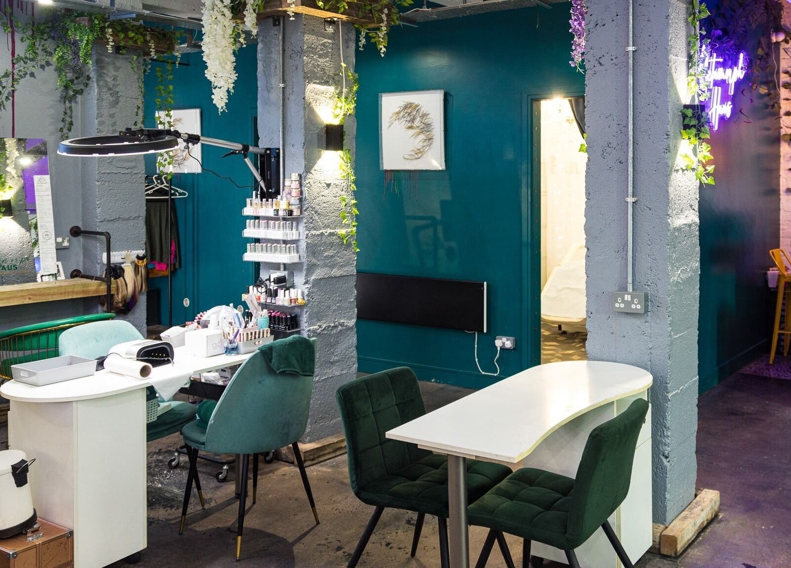 Stylish interior of Metamorph Haus, a beauty salon in Liverpool, England, GB with modern decor and vibrant lighting.