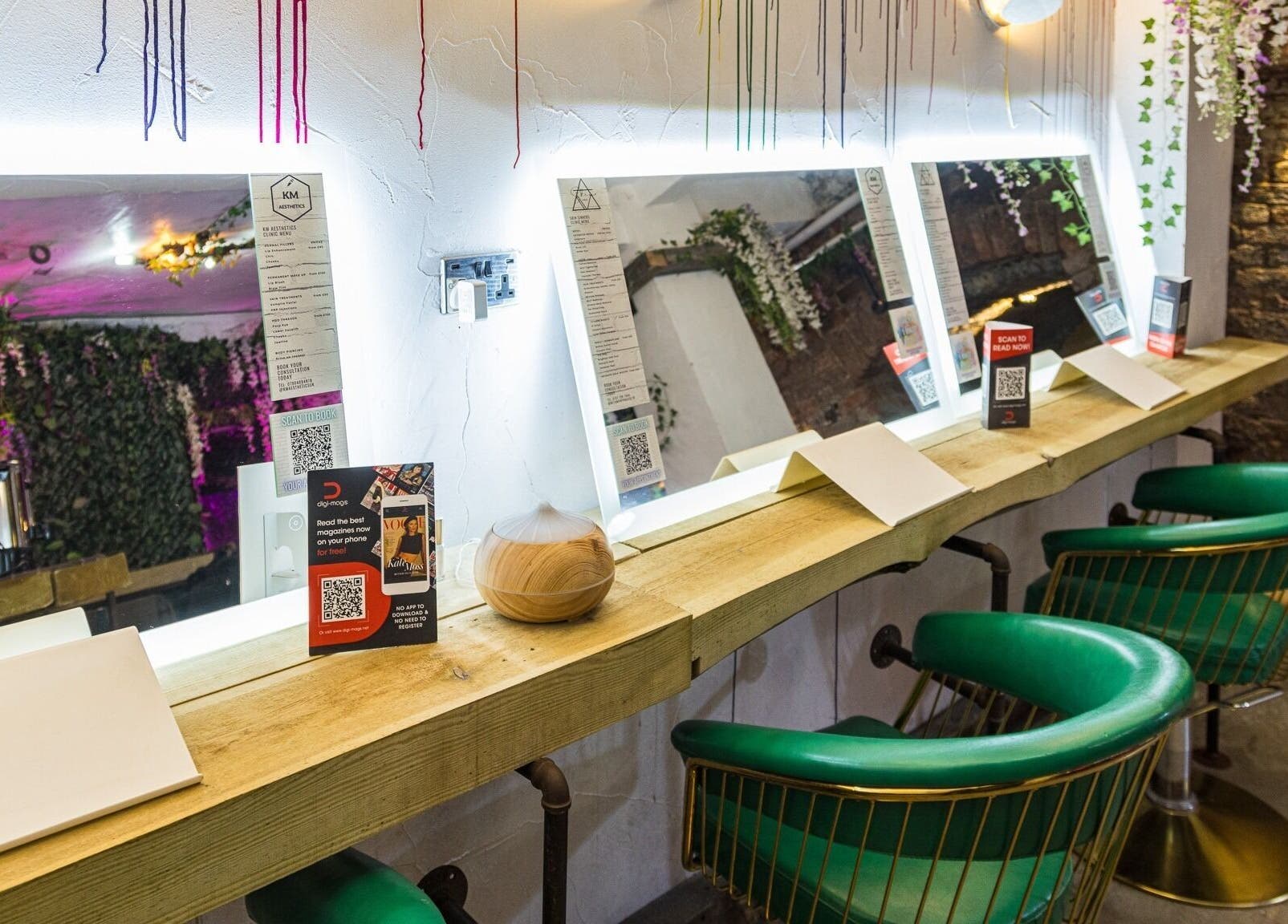 Chic beauty mirrors at Metamorph Haus, Liverpool, England, GB, adorned with hanging greenery.