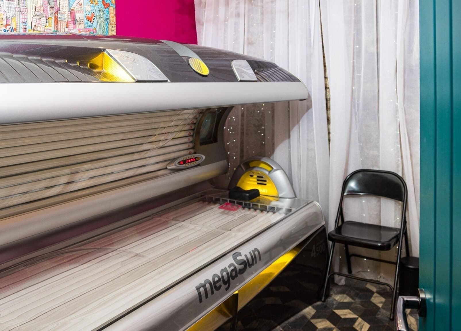 High-tech sunbed and chair at Metamorph Haus, Liverpool, England, GB, offering premium tanning experience.