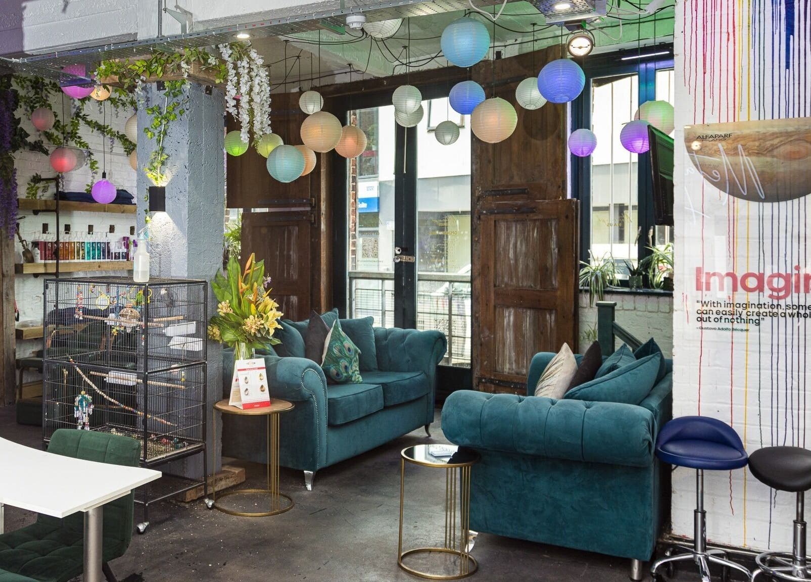 Cozy seating area with vibrant lighting at Metamorph Haus, Liverpool, England, GB, highlighting beauty and wellness.