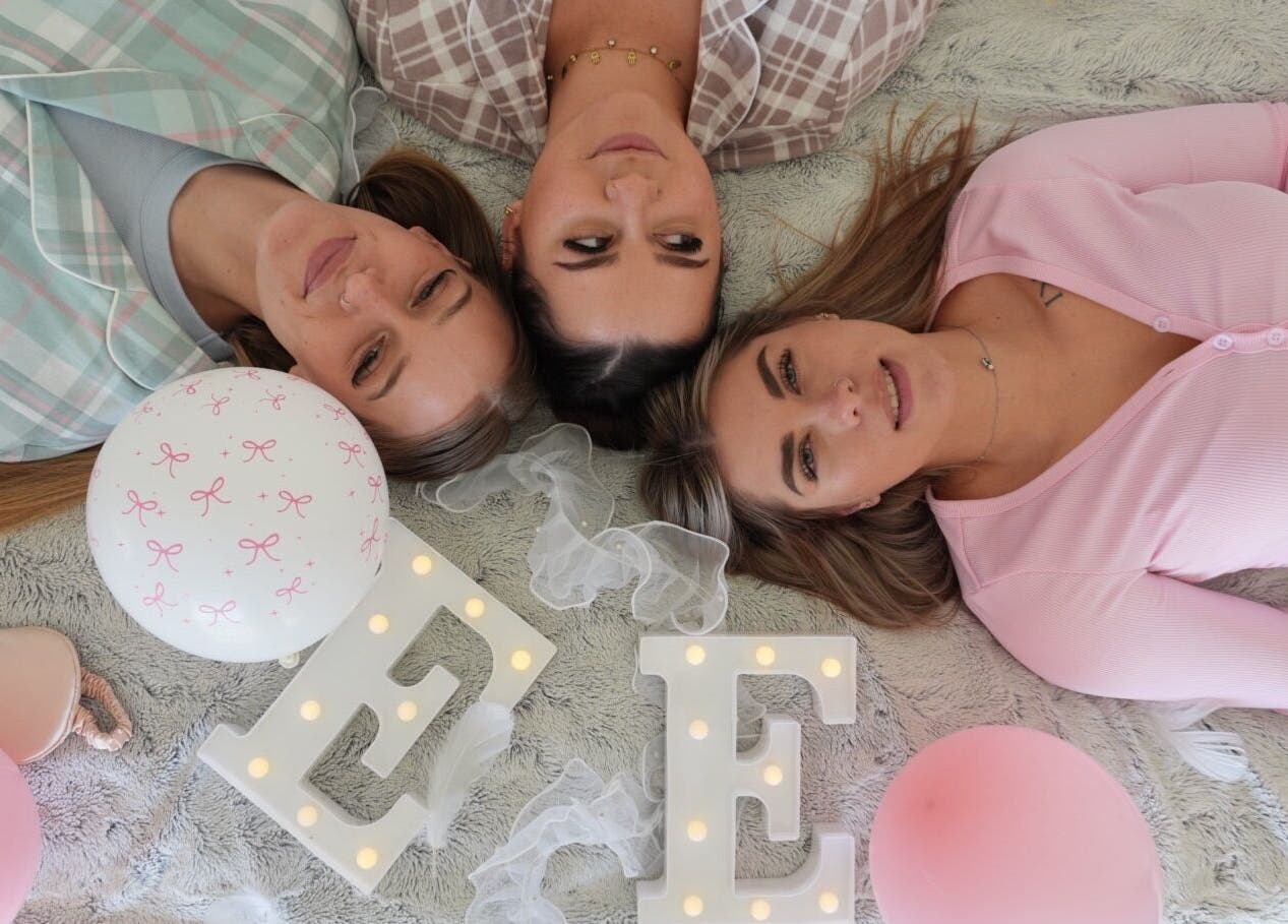 Three women relaxing at Evil Eyes Beauty Studio in Roodepoort, Gauteng, ZA. Surrounded by soft decor and balloons.