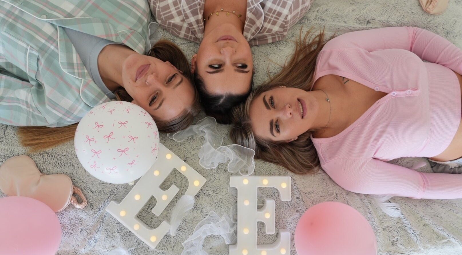 Three women relaxing at Evil Eyes Beauty Studio in Roodepoort, Gauteng, ZA. Surrounded by soft decor and balloons.