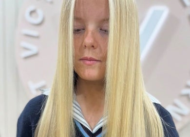 Woman with straight blonde hair at Victoria Melbourne Stylist, Melbourne, Victoria, AU.