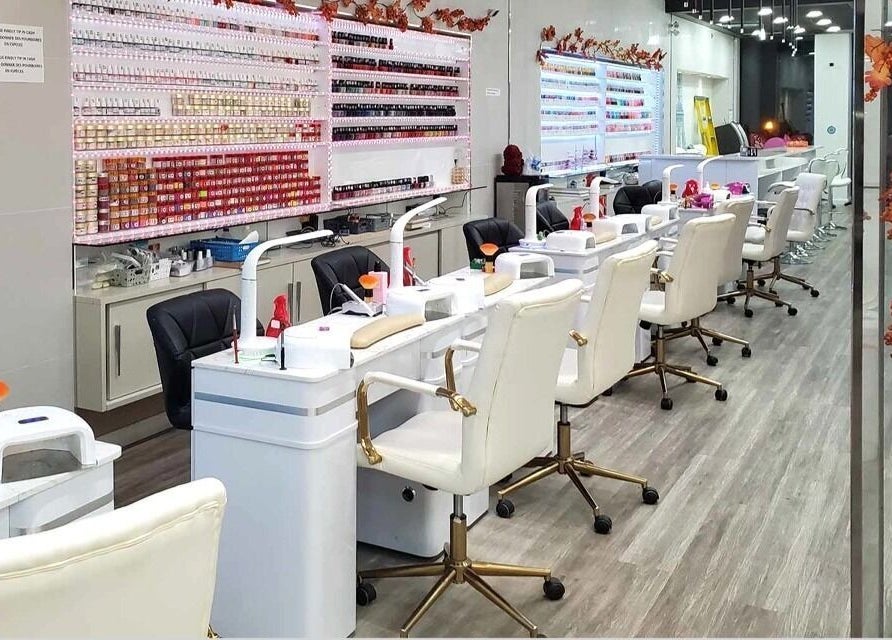 Interior of Ongles McGill, a modern nail salon in Montréal, Québec, CA with chic white stations and polish display.
