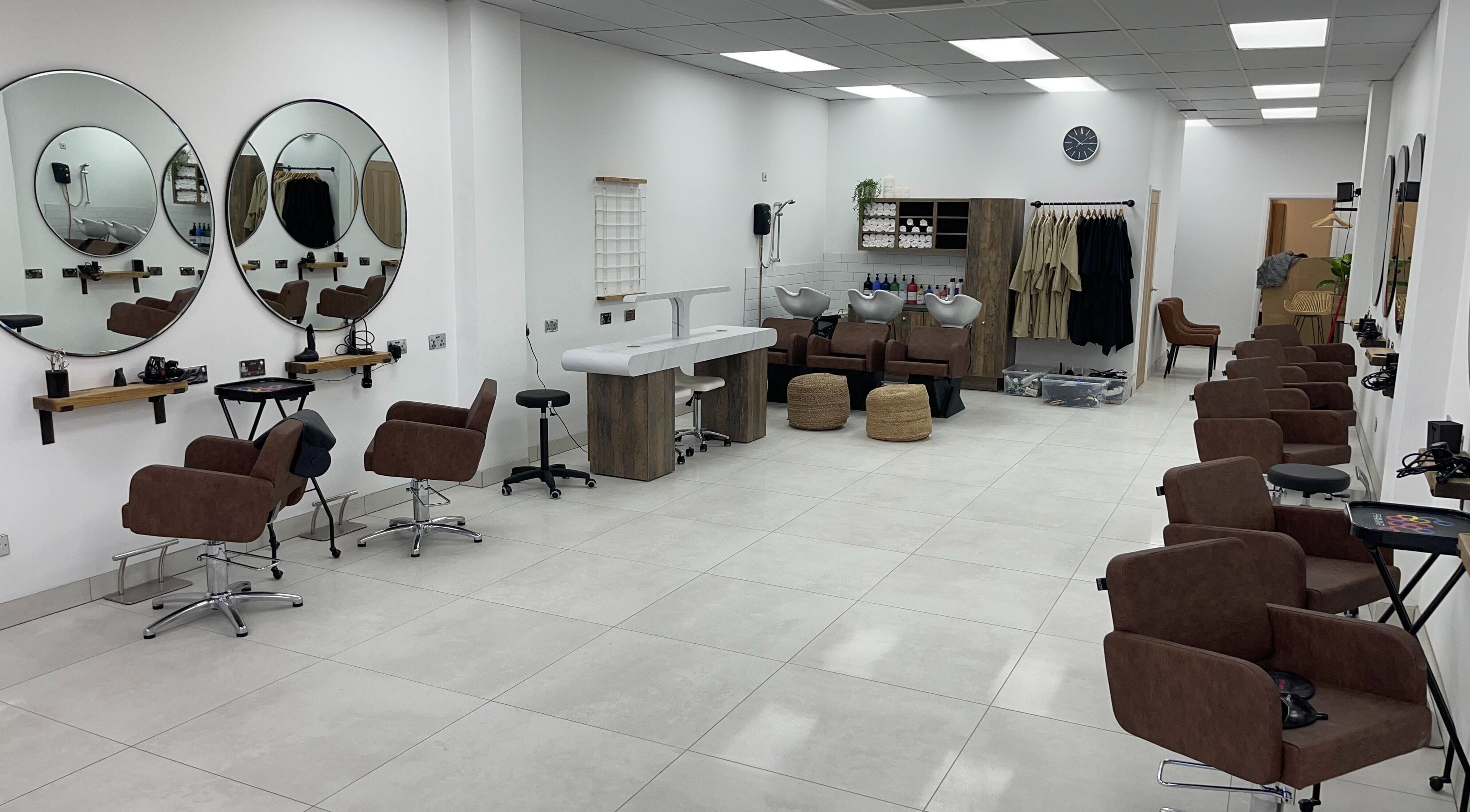 Stylish interior of M Hair and Beauty in Nottingham, England, GB featuring elegant salon chairs and mirrors.