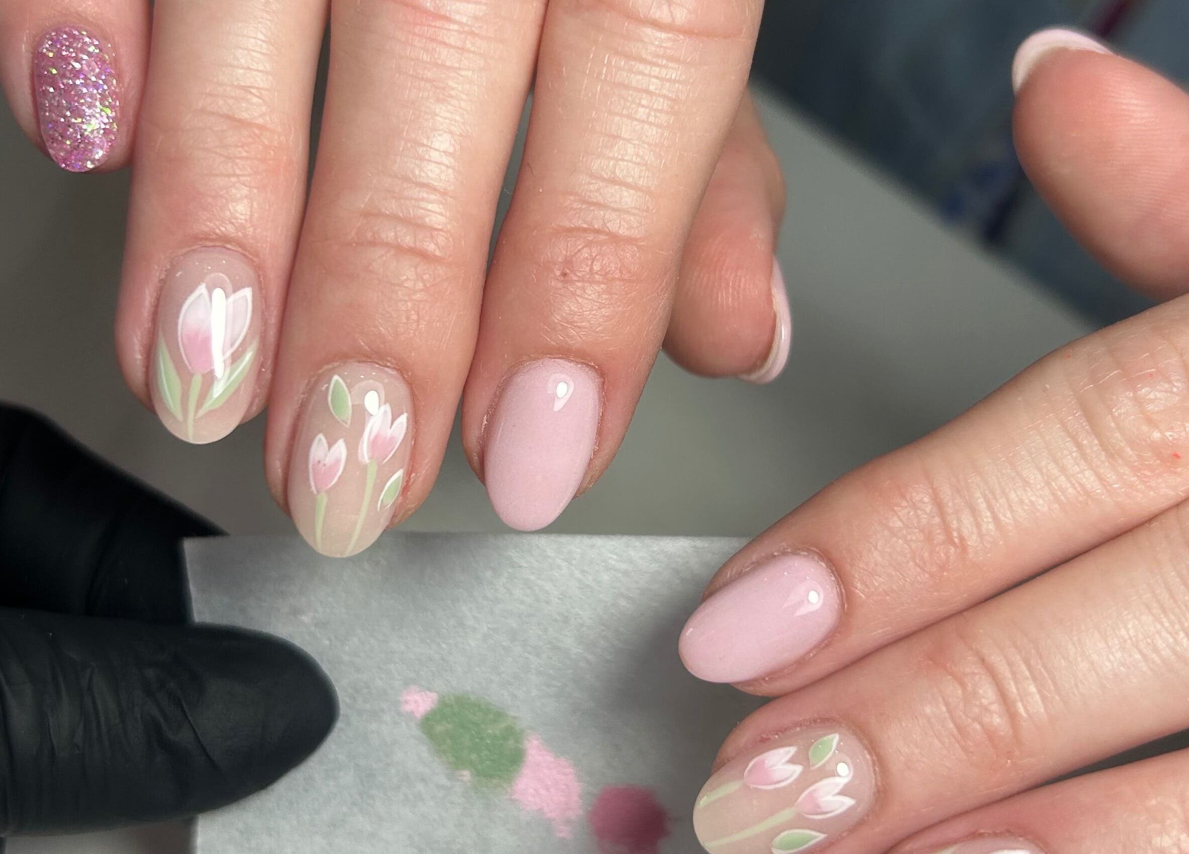 Elegant floral nail art at LILYMAE Beauty Esthetics & Co, Alberton, Gauteng, ZA, showcasing delicate pink designs.
