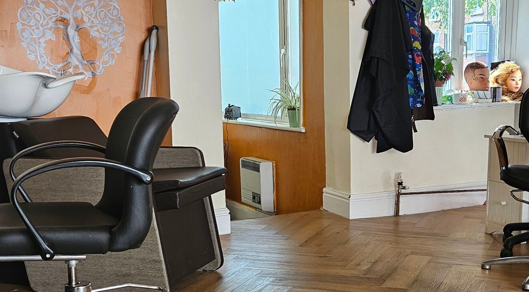 Modern salon interior at Inclusion Hair and Beauty in Scarborough, England, GB with chic styling chairs.
