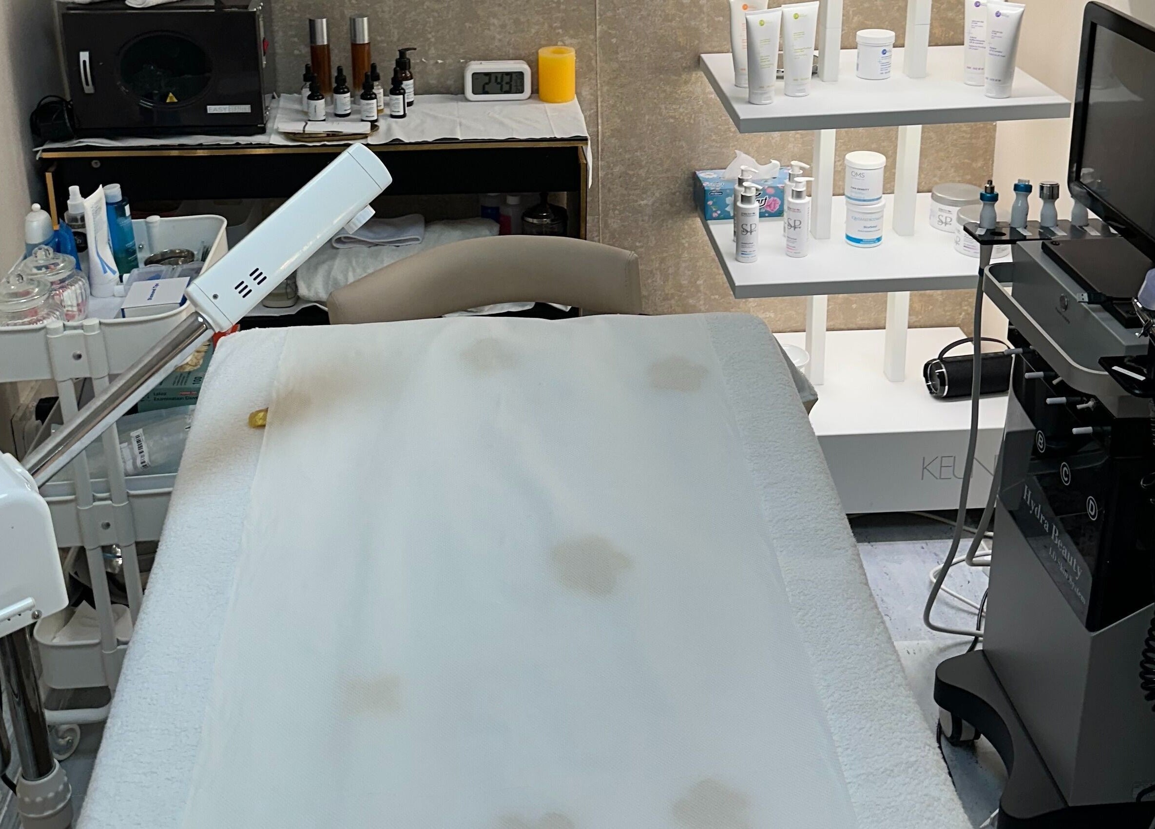 Treatment room at Juan Salon, Dubai, AE featuring modern skincare equipment and luxury products.