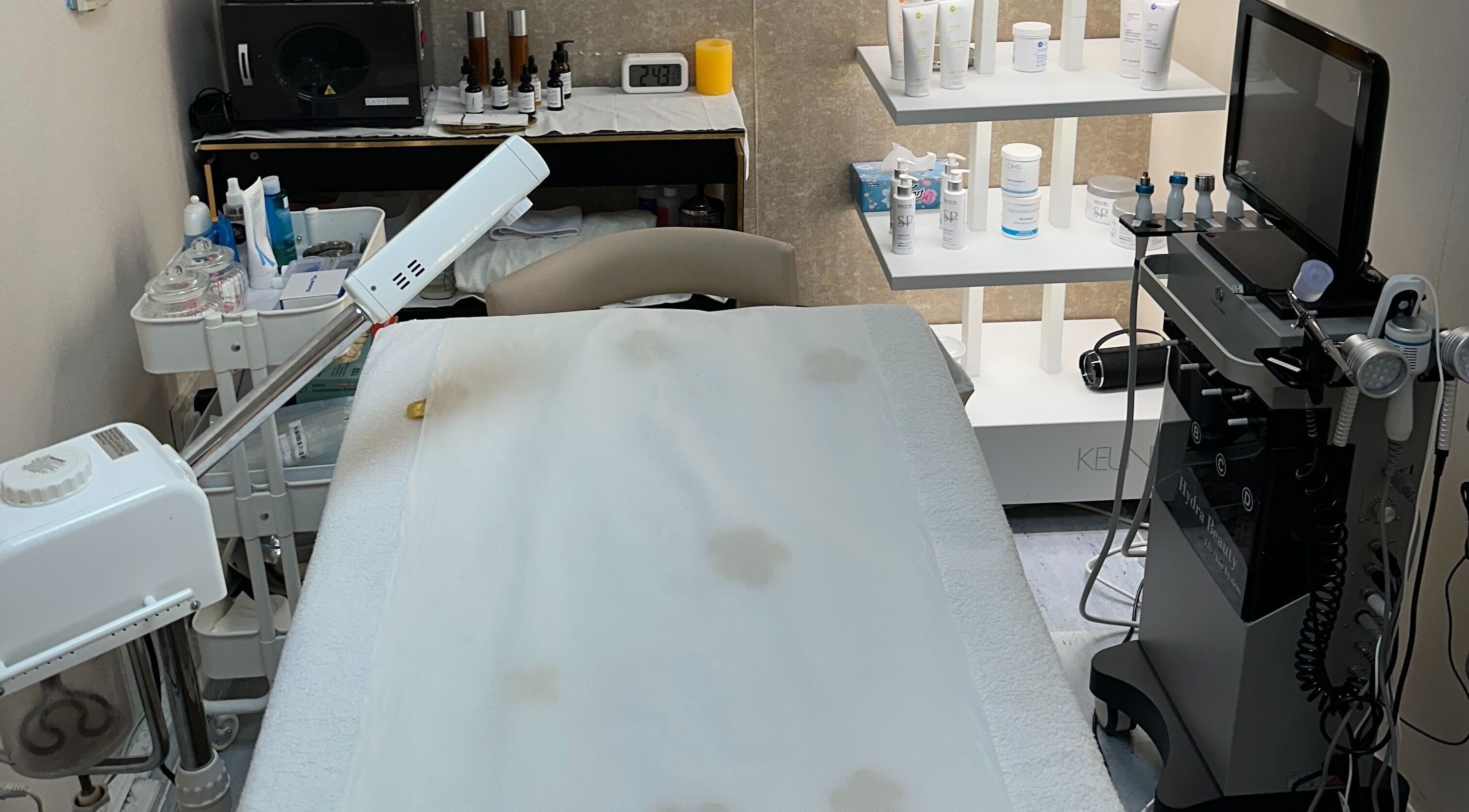 Treatment room at Juan Salon, Dubai, AE featuring modern skincare equipment and luxury products.