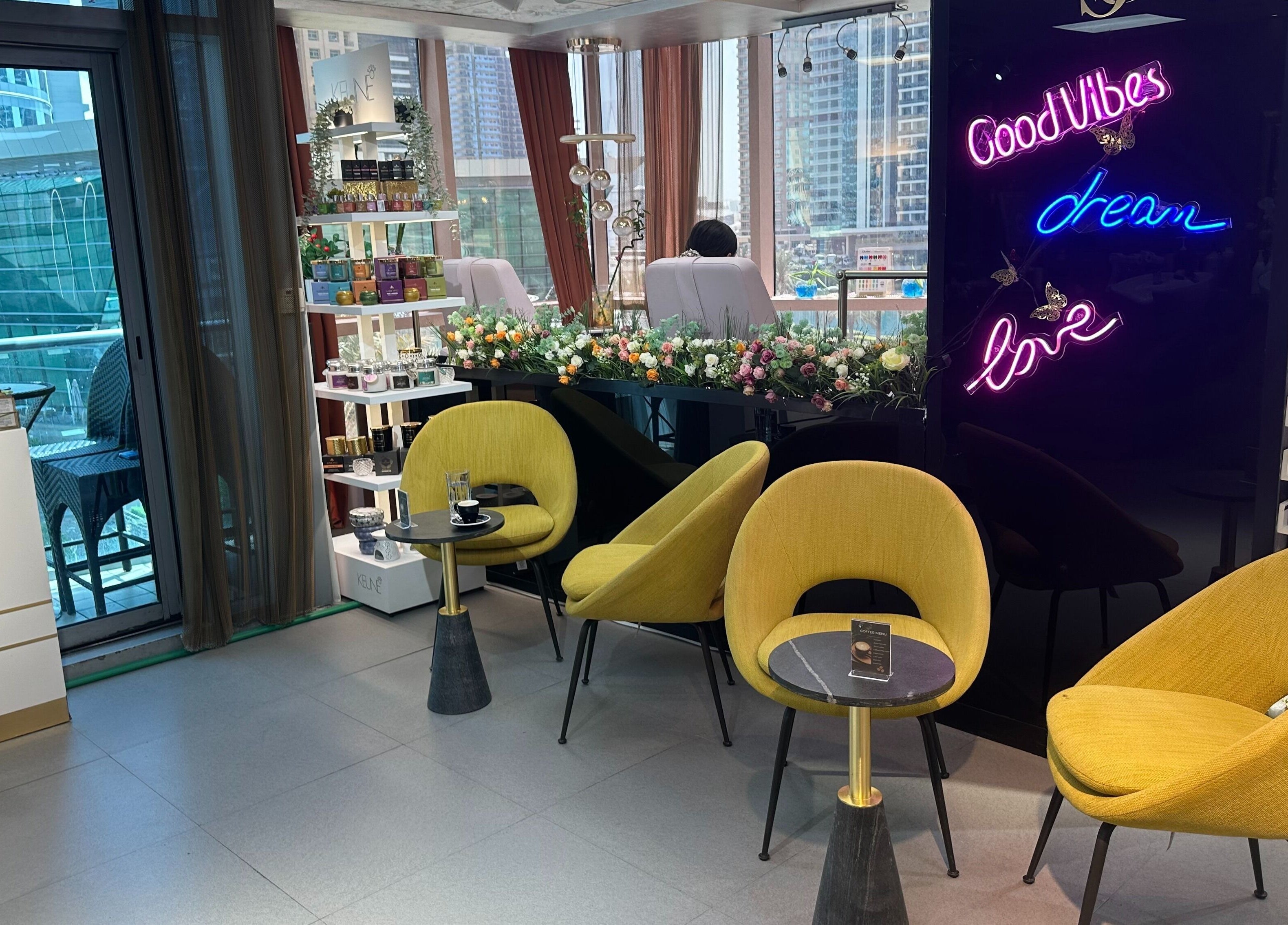 Stylish seating and neon lights at Juan Salon, Dubai, AE. Cozy modern ambiance perfect for relaxation.