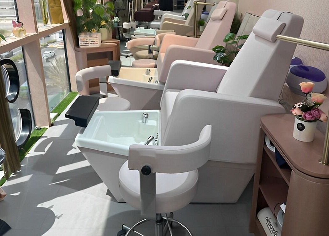 Relaxing nail spa chairs at Juan Salon, Dubai, AE, offering a serene beauty experience with elegant decor.