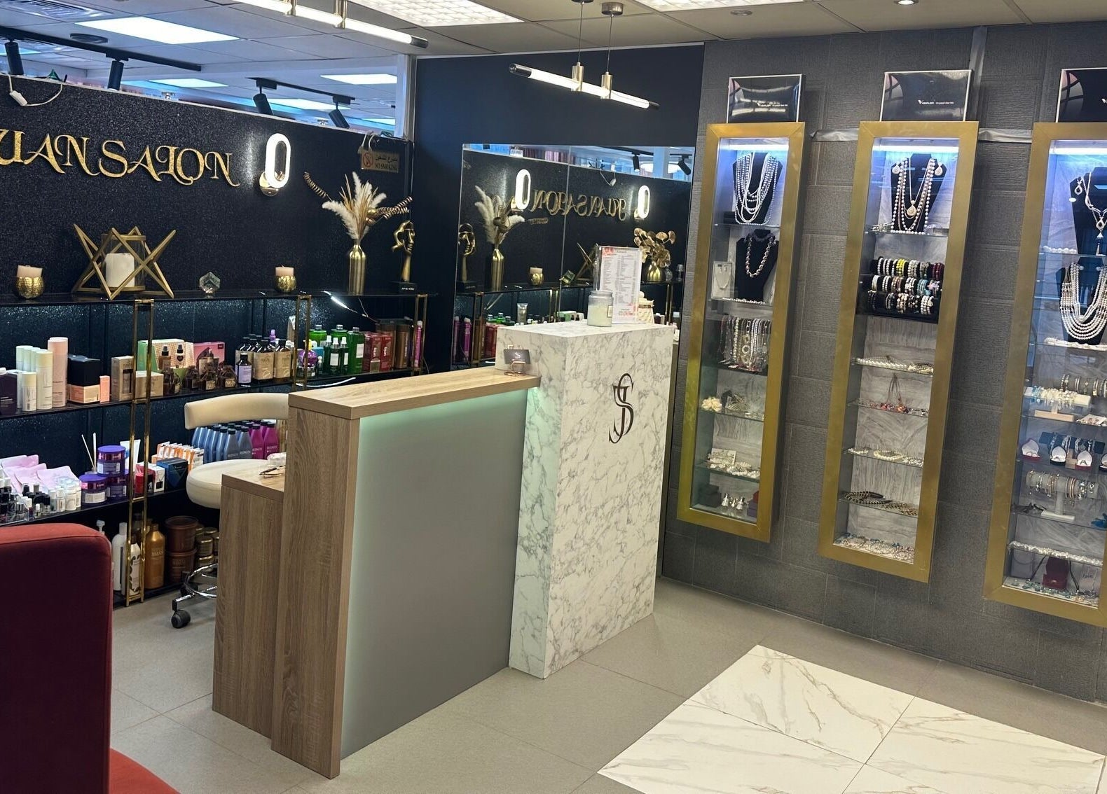 Interior of Juan Salon, a beauty venue in Dubai, AE, showcasing products and jewelry displays.