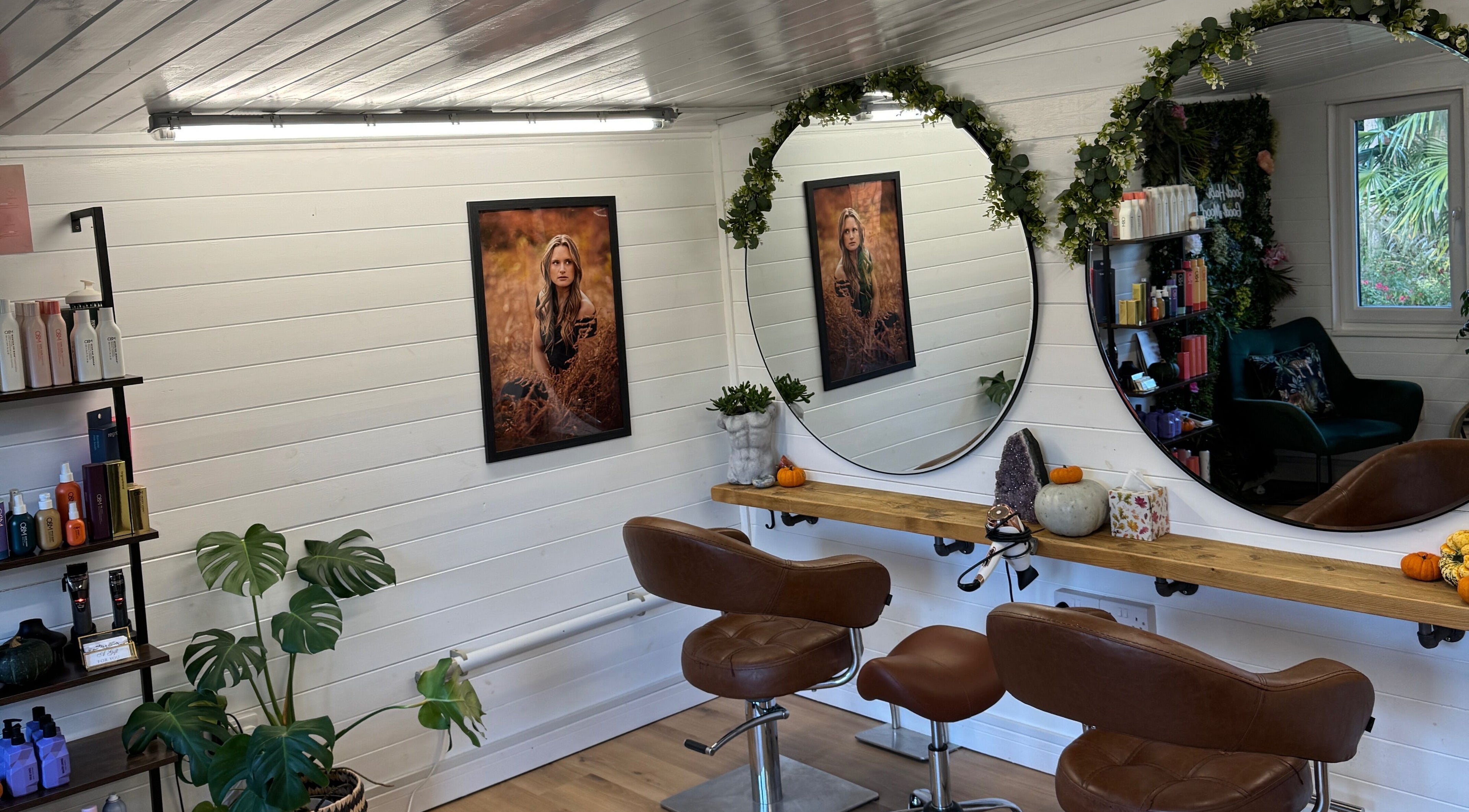 Rustic salon interior at Joey Galvin Hair, Guildford, England, GB with elegant mirrors and lush greenery.