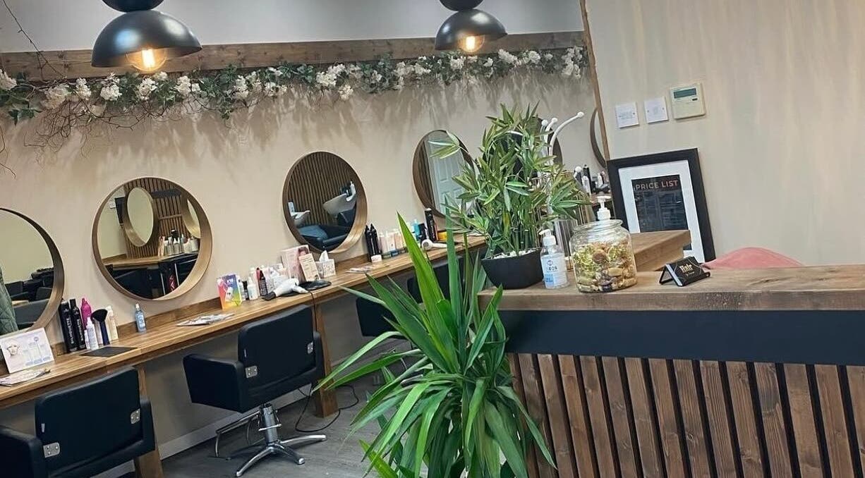 Chic interior of Hair by Jasmine, Carrick-On-Shannon, Roscommon, IE showcasing stylish mirrors and lush plants.
