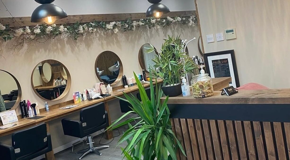 Chic interior of Hair by Jasmine, Carrick-On-Shannon, Roscommon, IE showcasing stylish mirrors and lush plants.