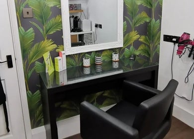 Modern salon setup at Hair at Hampton, Church Crookham, England, GB, featuring chic decor and styling tools.