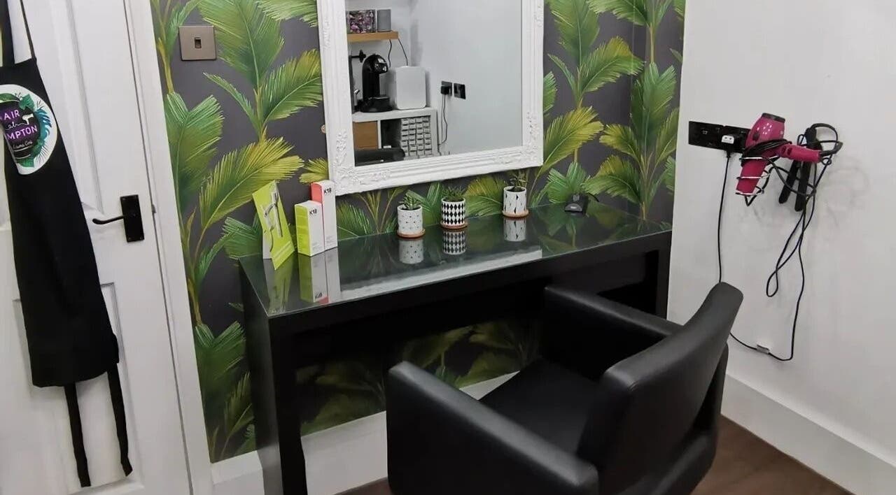 Modern salon setup at Hair at Hampton, Church Crookham, England, GB, featuring chic decor and styling tools.