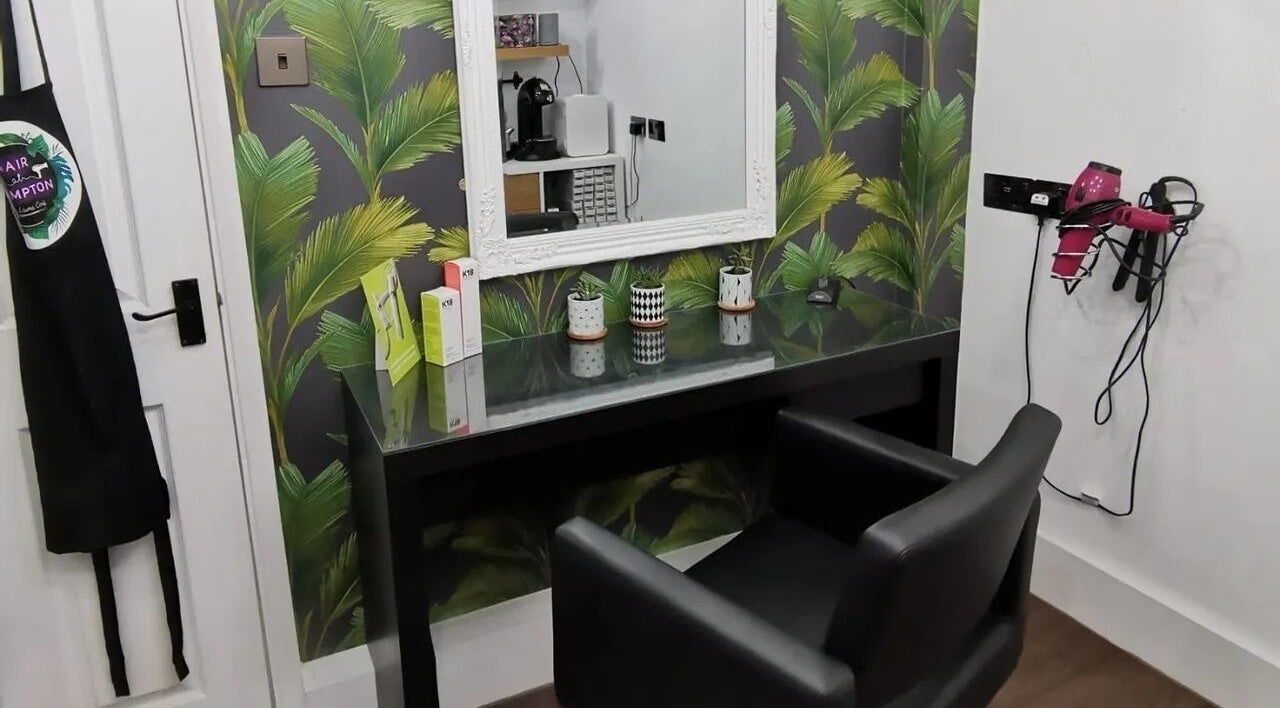 Modern salon setup at Hair at Hampton, Church Crookham, England, GB, featuring chic decor and styling tools.