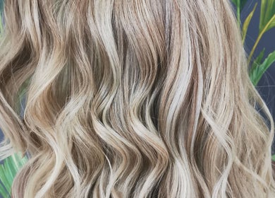Beautiful blonde wavy hairstyle at Hair at Hampton, Church Crookham, England, GB.