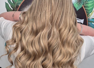 Voluminous blonde waves styled at Hair at Hampton, Church Crookham, England, GB with a chic salon background.