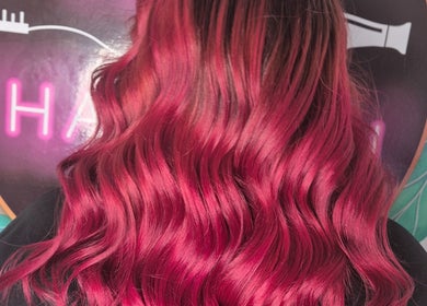 Vibrant red wavy hair showcased at Hair at Hampton, Church Crookham, England, GB.