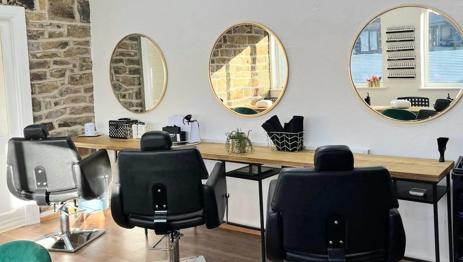 Chic styling chairs at Whitehead & Booth Salon & Permanent Jewellery, Sheffield, England, GB with round mirrors.