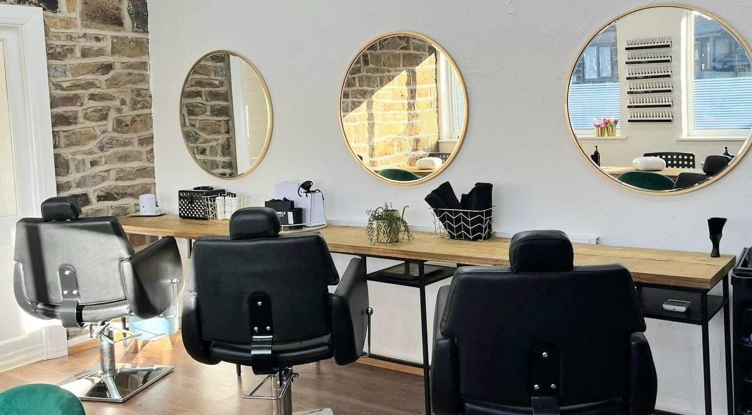 Chic styling chairs at Whitehead & Booth Salon & Permanent Jewellery, Sheffield, England, GB with round mirrors.
