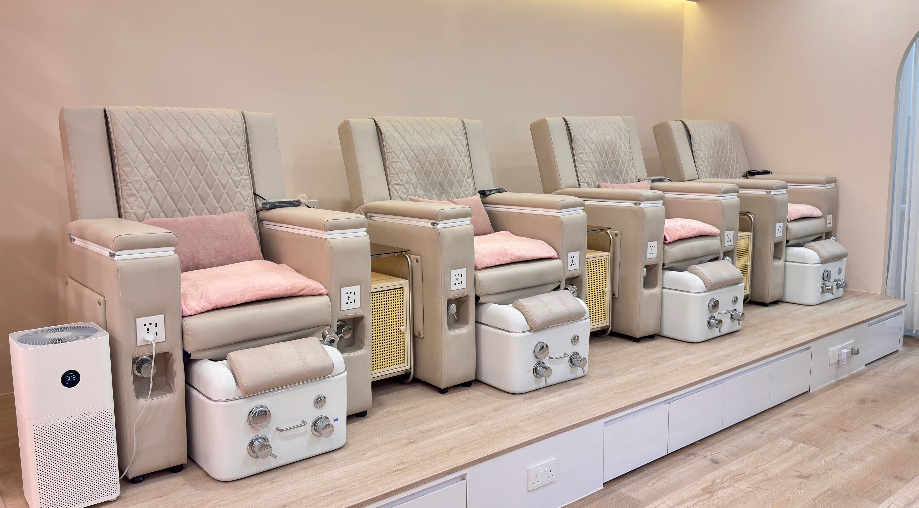Pedicure chairs at Dollhouse Nails - Citylink Mall, Singapore, offering relaxation and comfort in a chic setting.