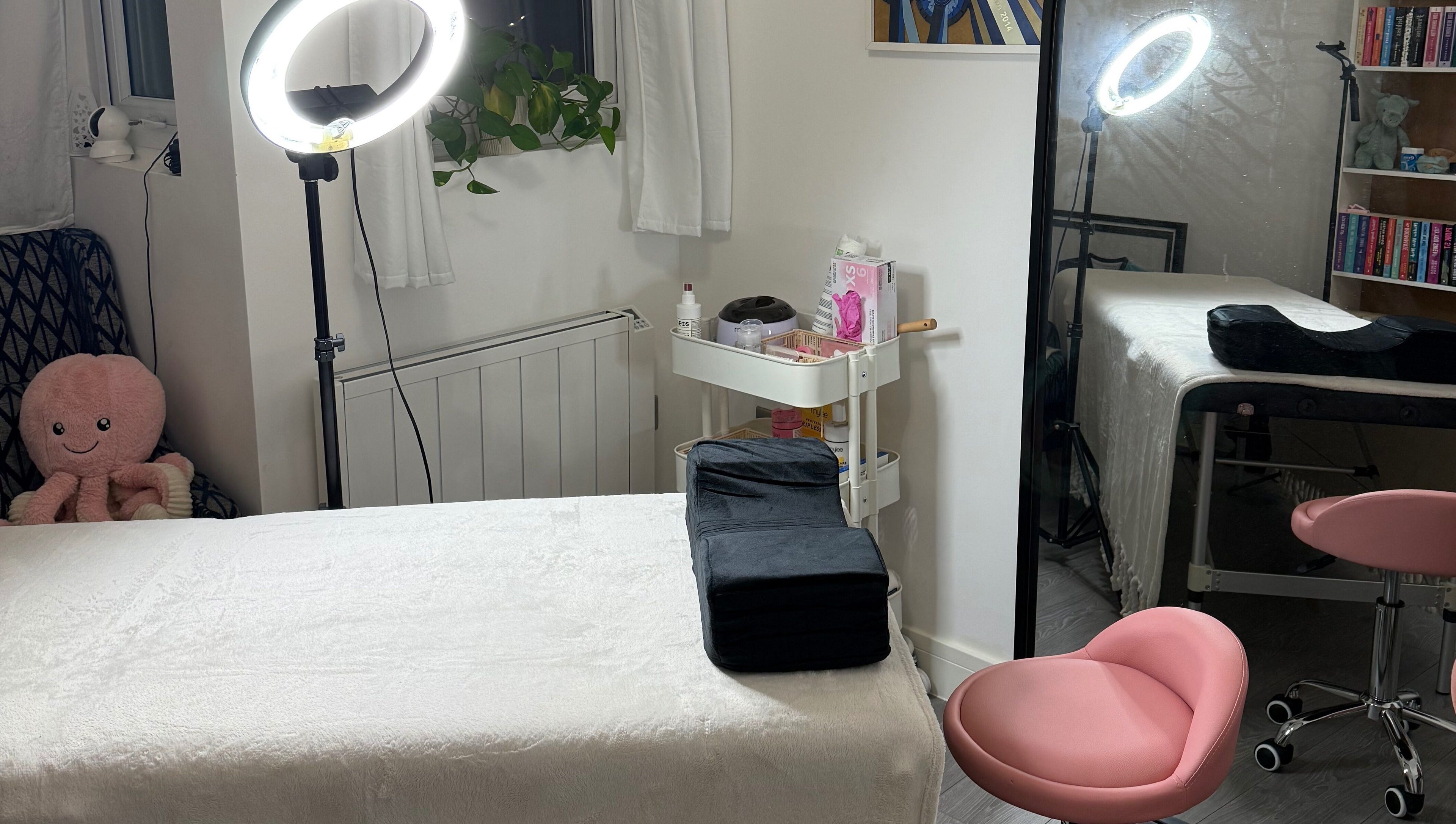 Cozy spa therapy room at LBBK, High Wycombe, England, GB featuring a massage table and soft lighting.