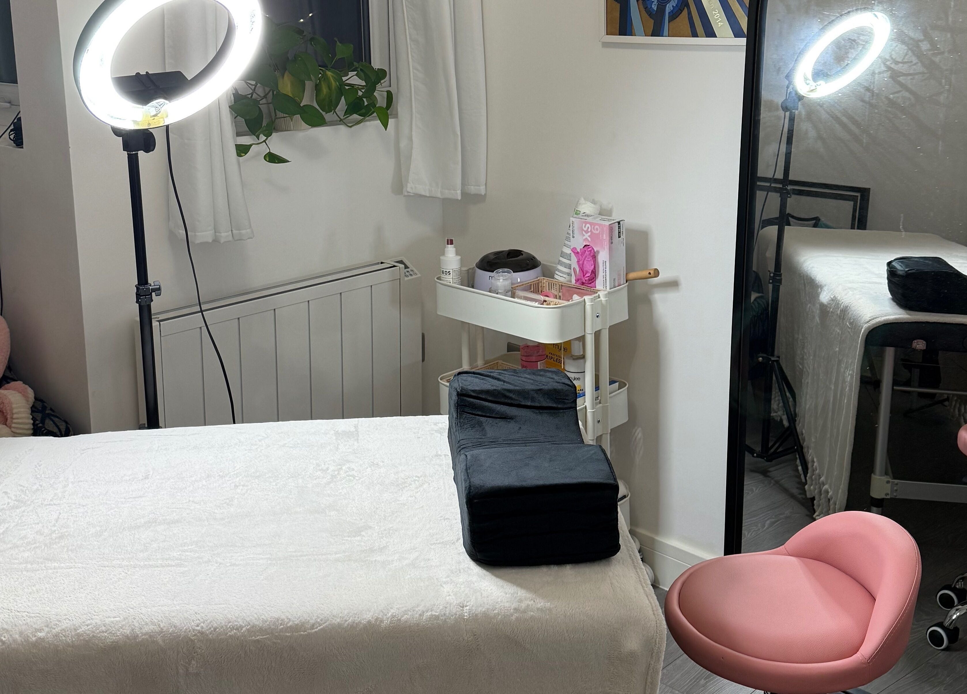 Cozy spa therapy room at LBBK, High Wycombe, England, GB featuring a massage table and soft lighting.