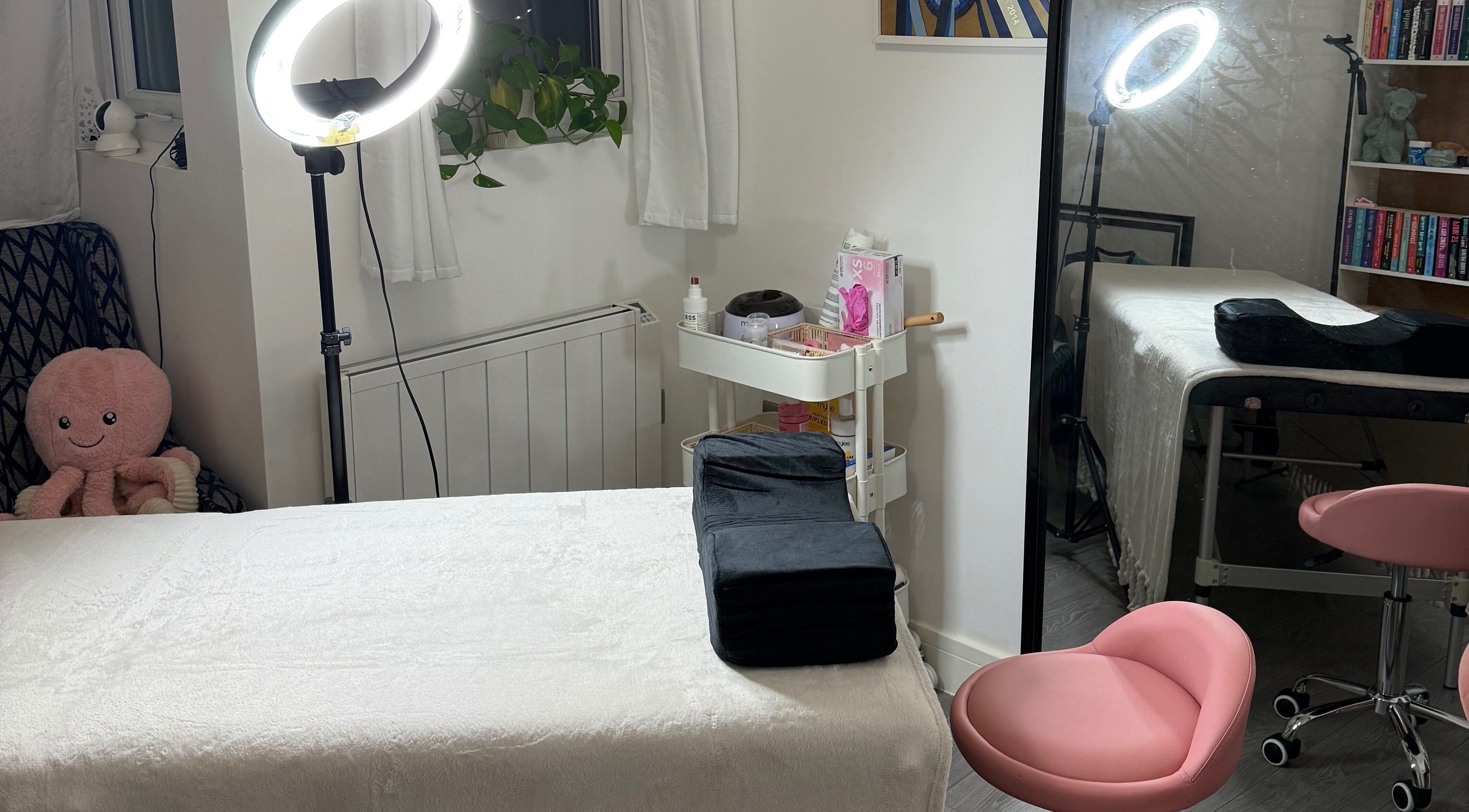 Cozy spa therapy room at LBBK, High Wycombe, England, GB featuring a massage table and soft lighting.