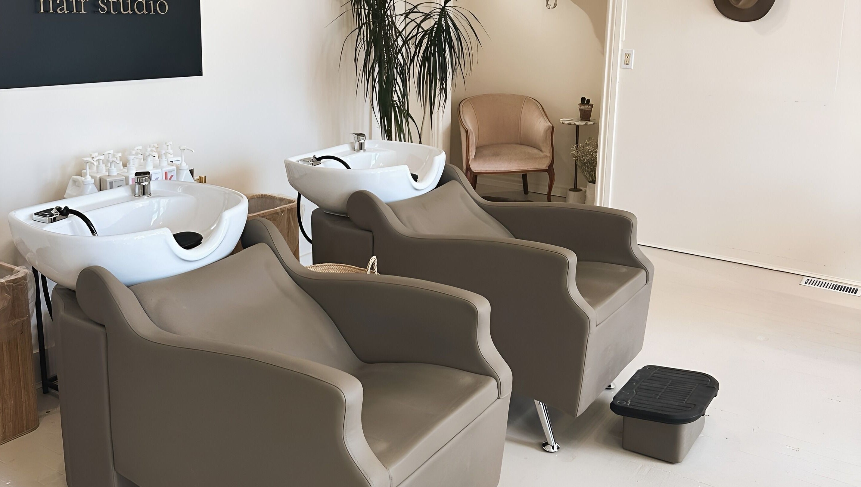 Modern salon wash stations at Odette Hair Studio, Prince Edward, Ontario, CA, featuring elegant seating.