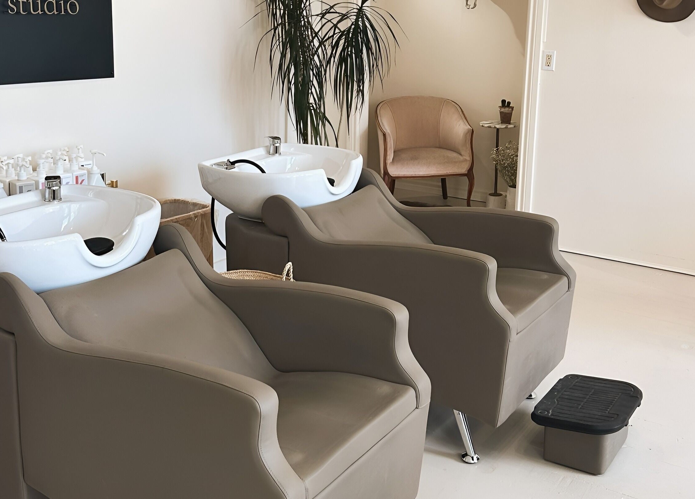 Modern salon wash stations at Odette Hair Studio, Prince Edward, Ontario, CA, featuring elegant seating.
