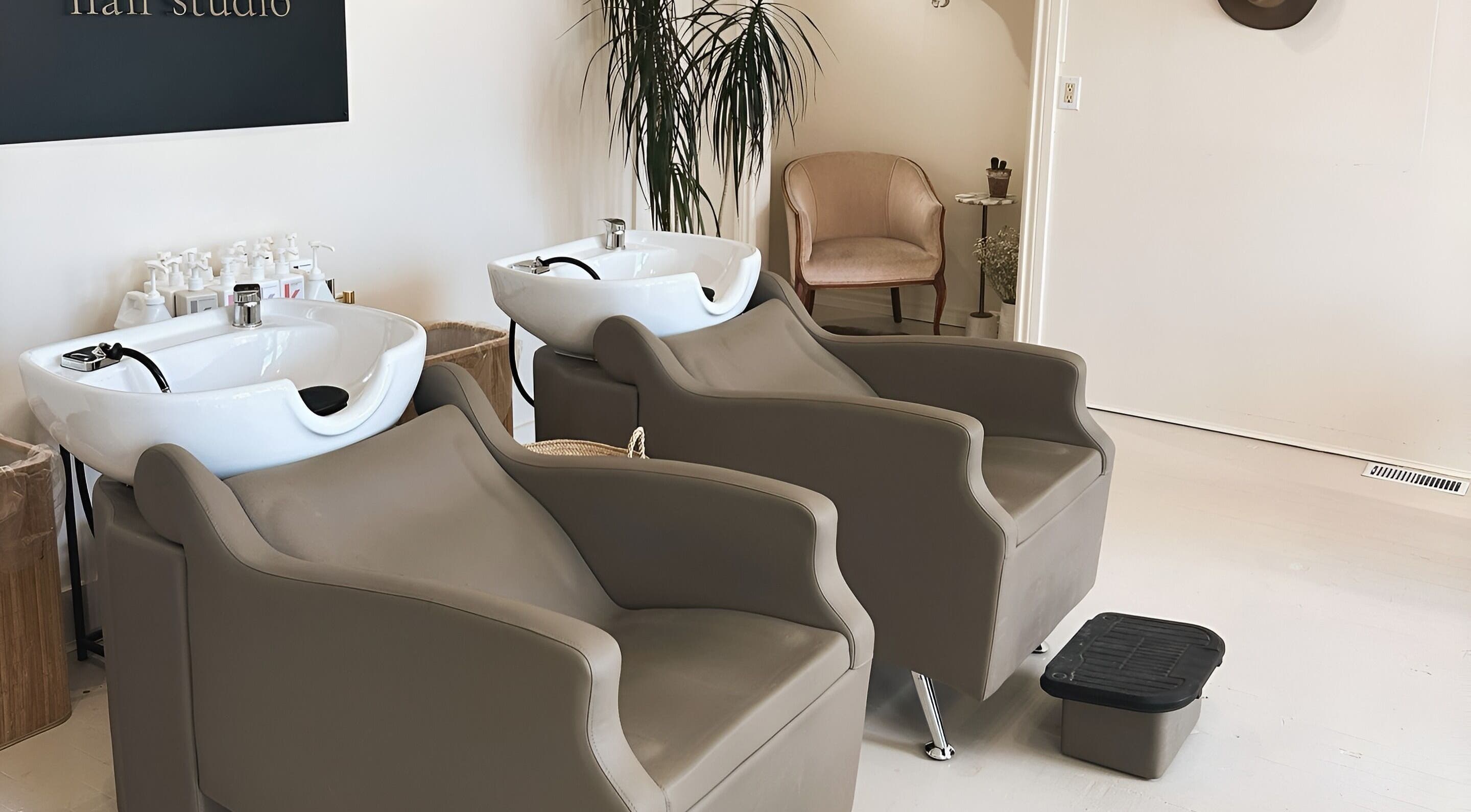 Modern salon wash stations at Odette Hair Studio, Prince Edward, Ontario, CA, featuring elegant seating.