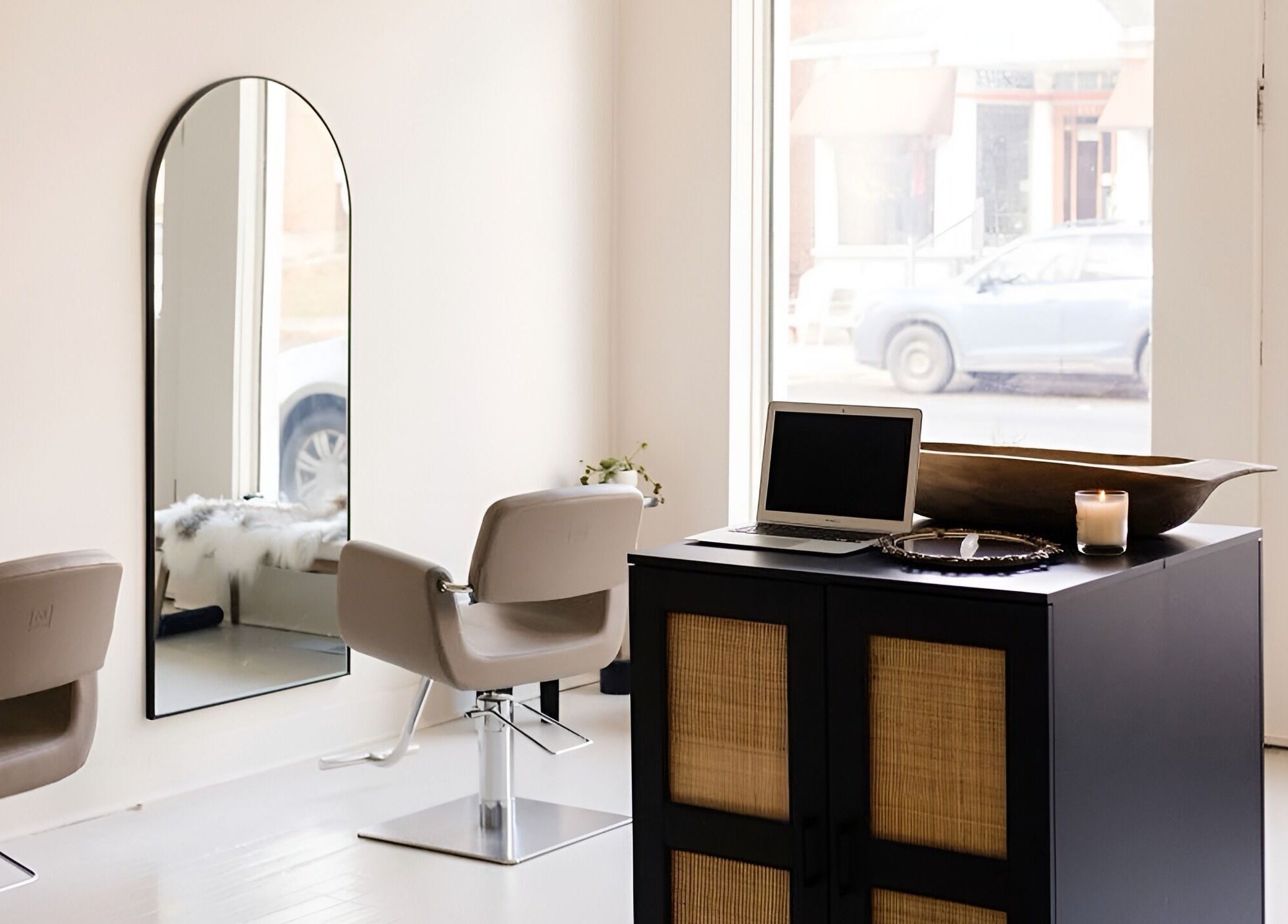 Modern interior of Odette Hair Studio, Prince Edward, Ontario, CA featuring stylish mirrors and chic seating.