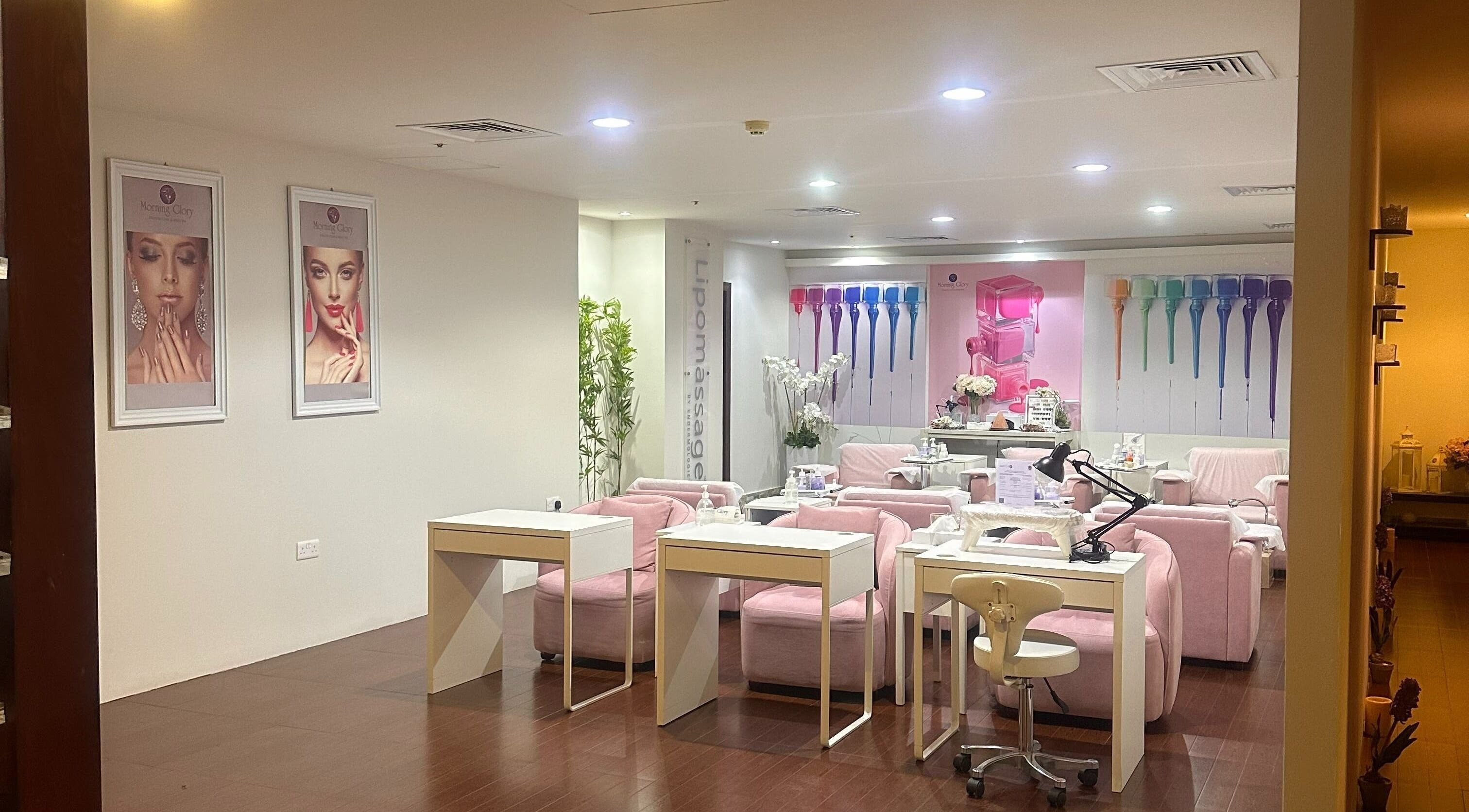 Chic interior of Morning Glory - Mirdif nail salon in Dubai, Dubai, AE with pink chairs and modern decor.